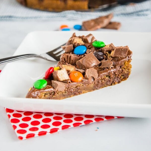 A piece of cake on a plate, with Cookie