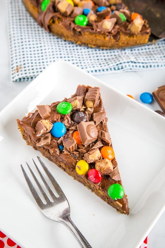 Cookie Pizza with a chocolate chip cookie base topped with frosting and all sorts of candy
