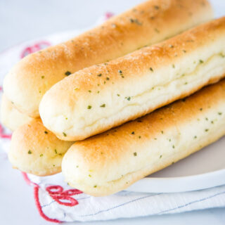 A close up of food, with Bread and Breadstick
