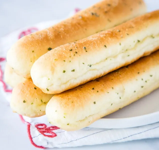 A close up of food, with Bread and Breadstick