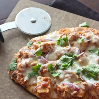 chicken tikka pizza on a board