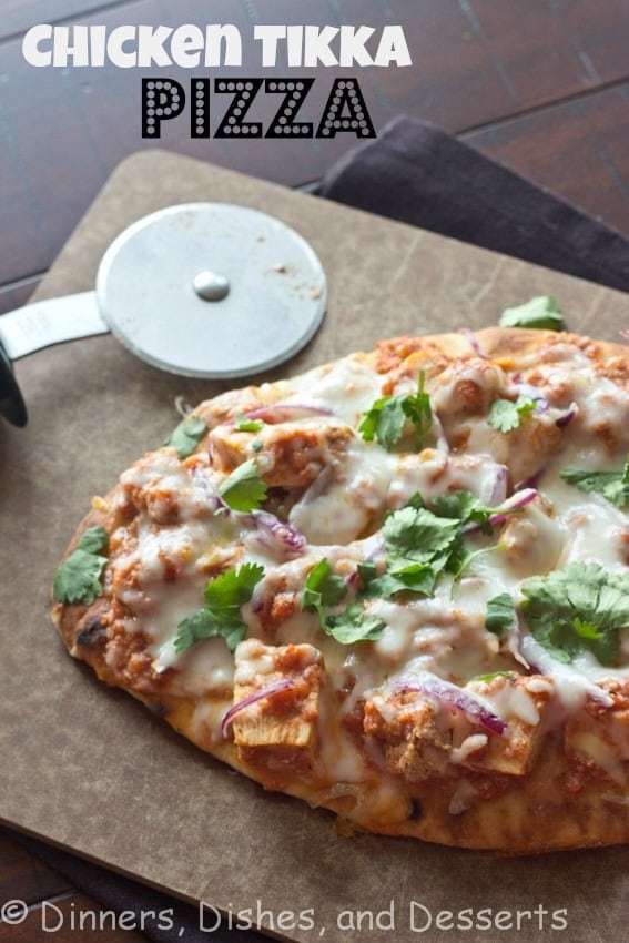 chicken tikka pizza on a board