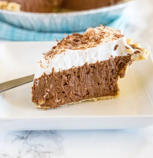 French Silk Pie - a rich and creamy chocolate pie with a layer of silky chocolate mousse topped with fresh whipped cream and chocolate shavings!  