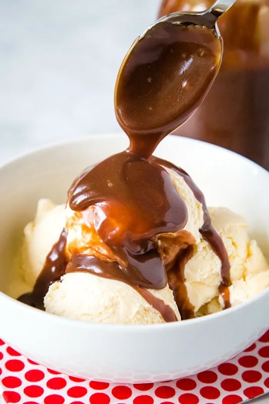 bowl of vanilla ice cream topped with hot fudge