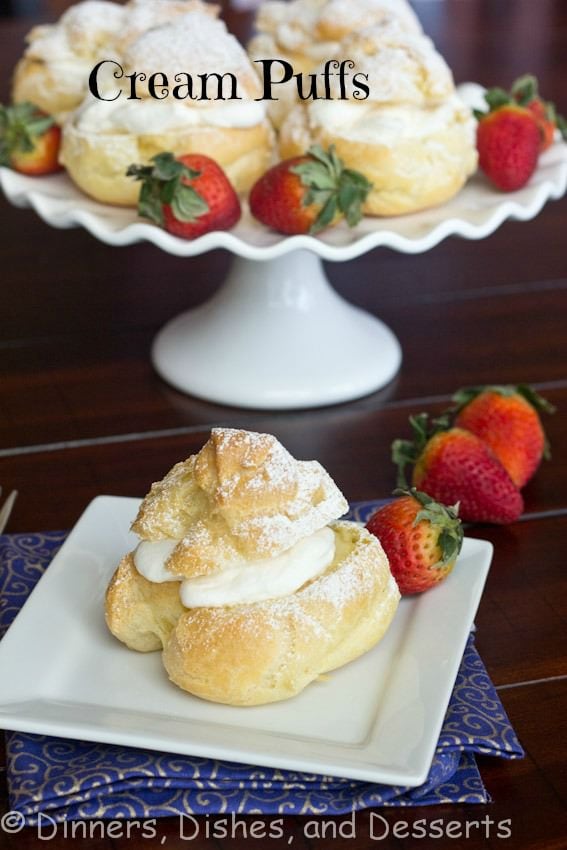 A plate of cream puffs on a table, with Cream and Pastry