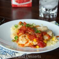 tilapia with tomatoes and orzo on a plate