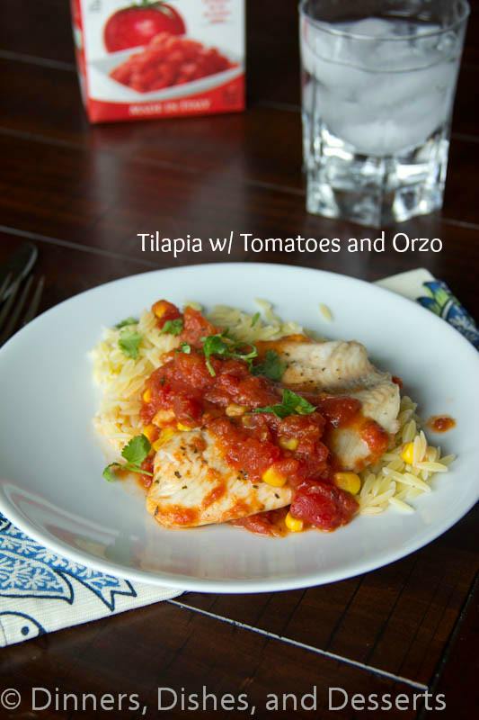 tilapia with tomatoes and orzo on a plate