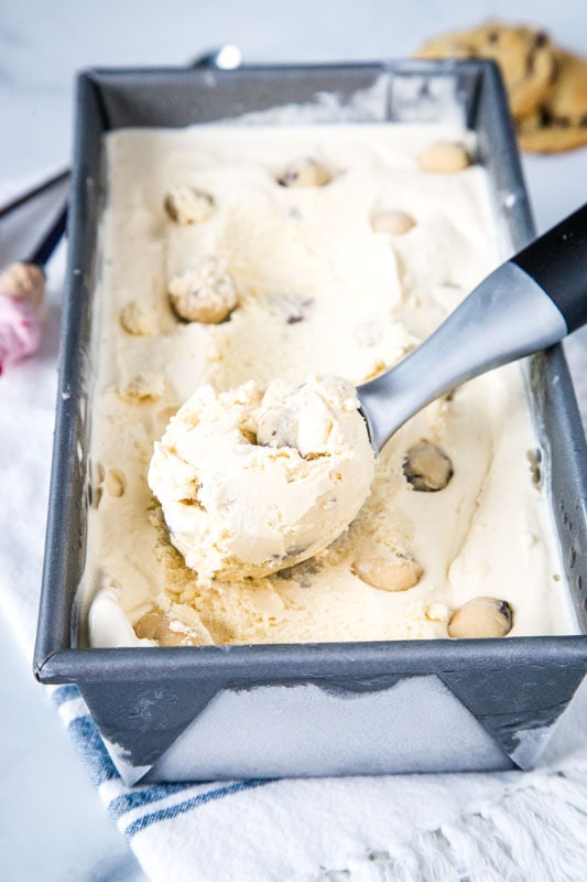 homemade cookie dough ice cream in container with a scoop of ice cream on top