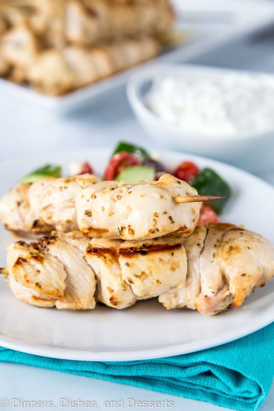 Greek chicken skewers with tzatziki sauce and greek salad