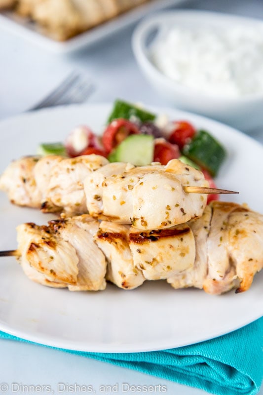 Chicken souvlaki with tzatziki sauce served with greek salad