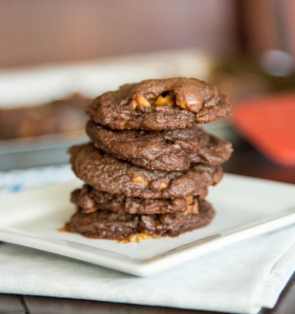 stack of chocolate rolo cookies on a white plate
