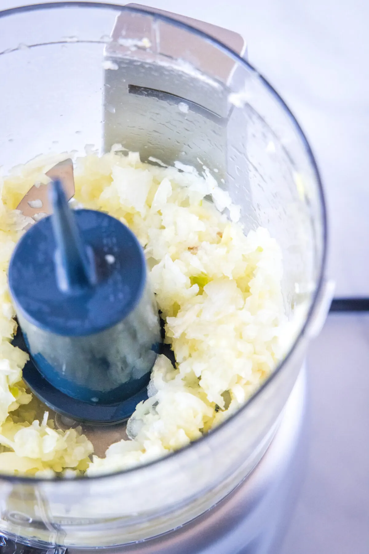 Minced onions, garlic, and ginger in a food processor