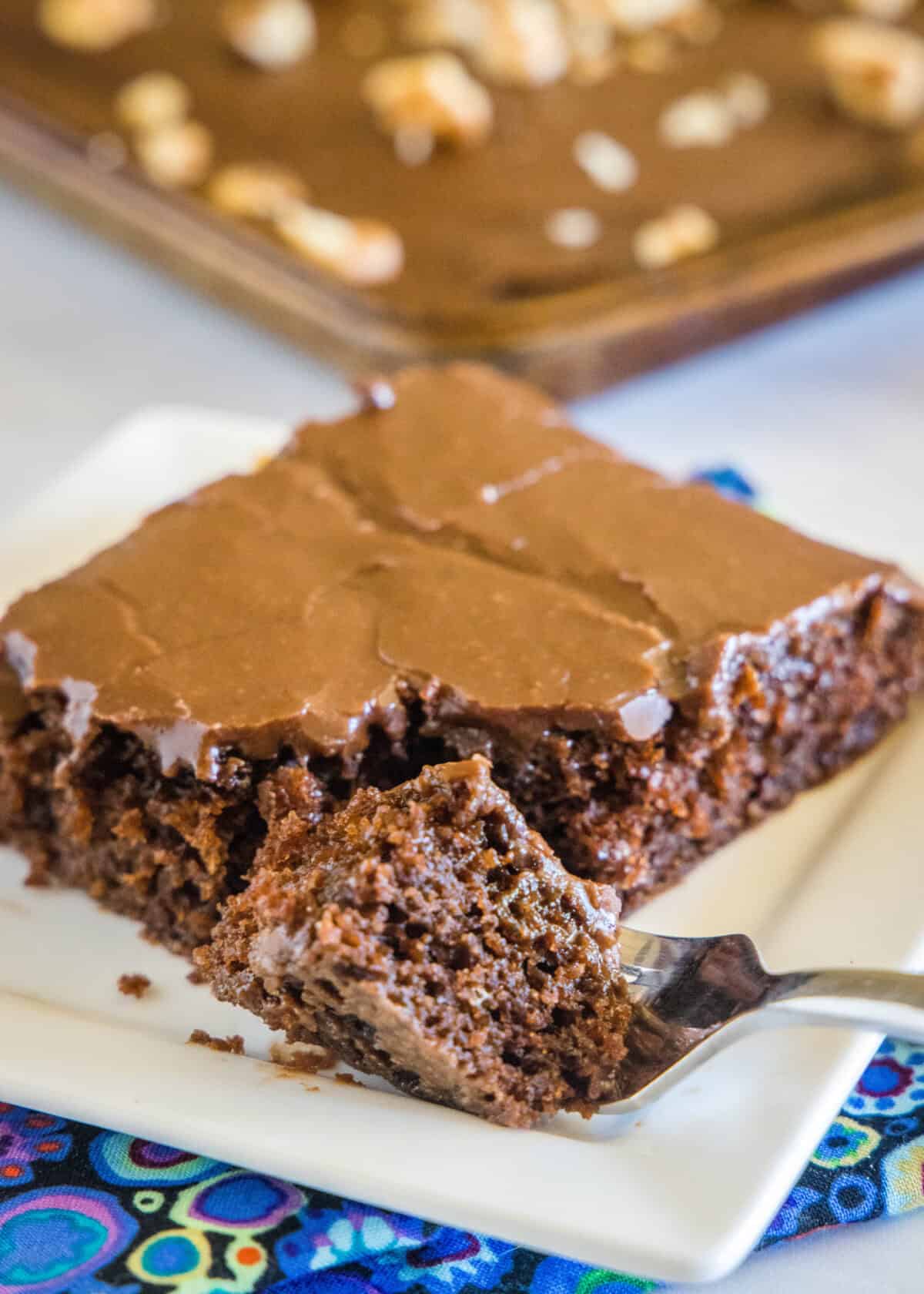 sheet cake slice on a plate with a piece on a fork