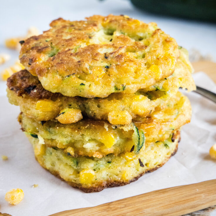 A stack of four zucchini and corn fritters
