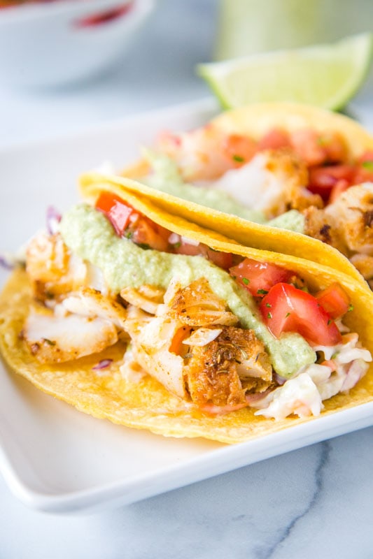 lightly seasoned cod in corn tortillas with pico de gallo and cabbage