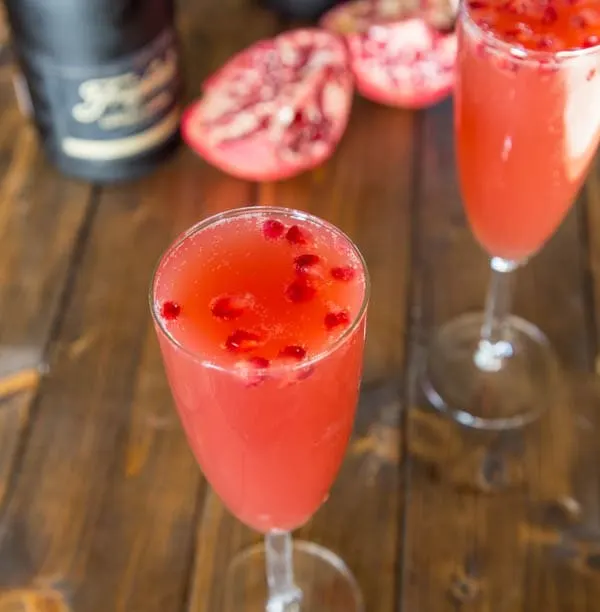 close up pomegranate mimosa in a glass