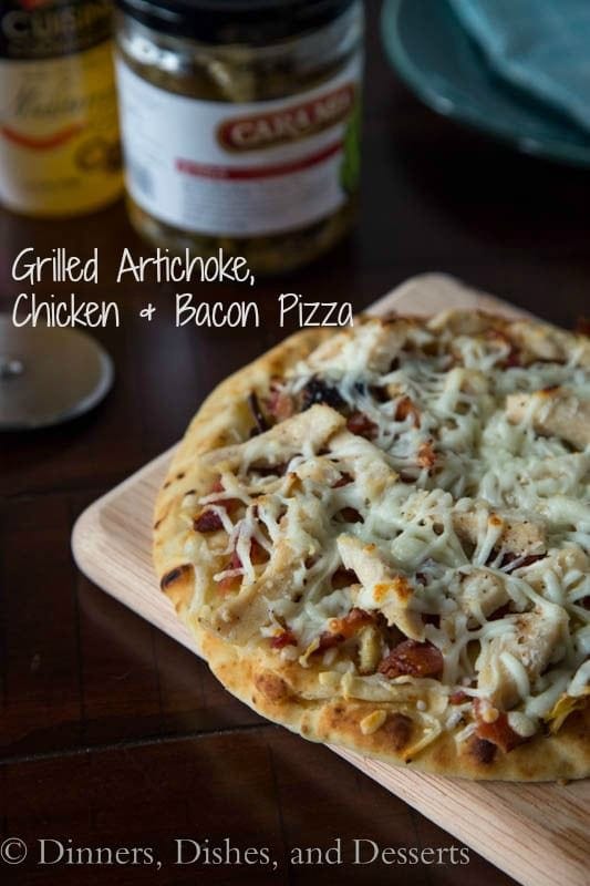 grilled artichoke chicken and bacon pizza on a board