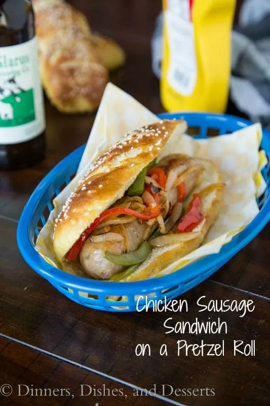 chicken sausage sandwich on a pretzel roll on a plate