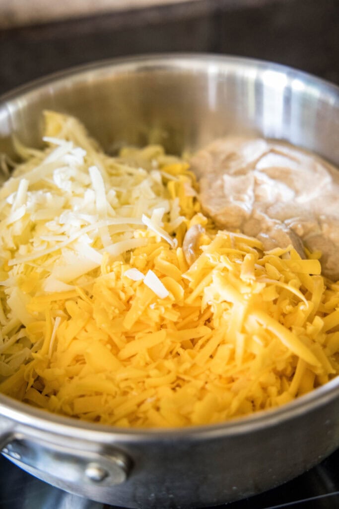 A bowl of shredded cheese and seasoned yogurt