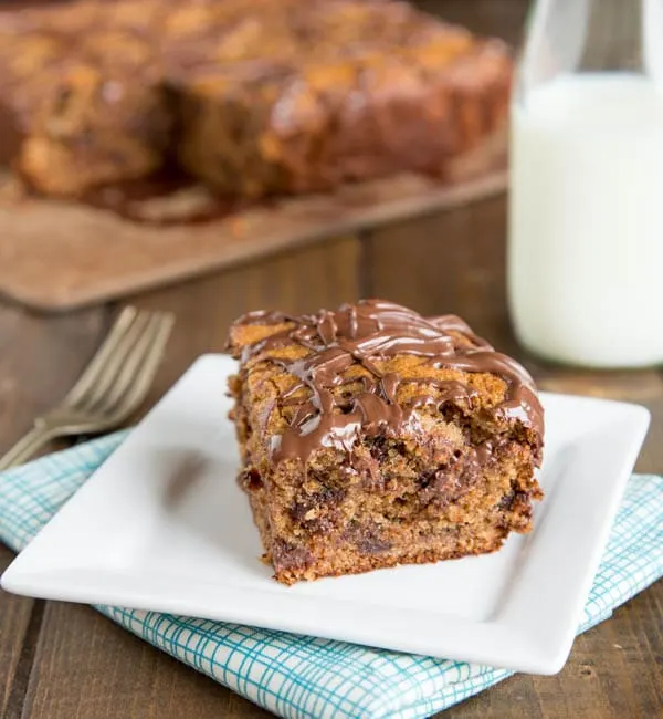 Peanut Butter Banana Snack Cake - This banana cake recipe is so tender and delicious with the peanut butter, chocolate chips, and topped with Nutella!