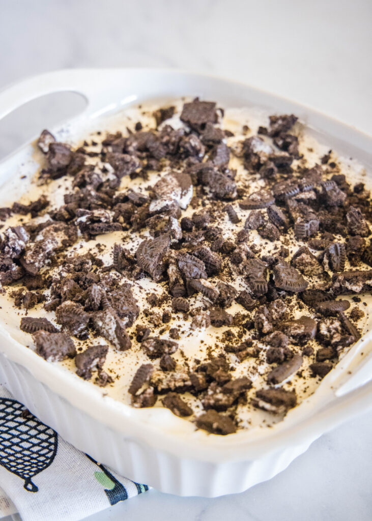 Overhead view of a baking dish filled with Oreo squares, topped with crumbled Oreos