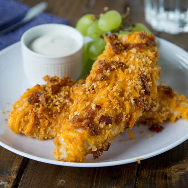 Cheddar Bacon Chicken Tenders are perfect for a quick weeknight meal. Homemade chicken tenders coasted in a cheddar and bacon breadcrumb mixture. Sure to please the entire family!