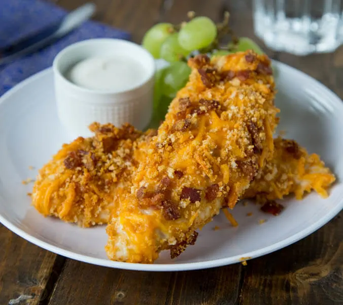 Cheddar Bacon Chicken Tenders are perfect for a quick weeknight meal. Homemade chicken tenders coasted in a cheddar and bacon breadcrumb mixture. Sure to please the entire family!