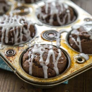 Chocolate Pumpkin Muffins with Pumpkin Spiced Glaze are a great treat to have around for breakfast, lunch box treats, or after school snacks.
