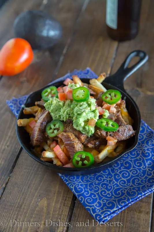 Carne Asada Fries - french fries topped with Carne Asada, melted cheese, and guacamole!