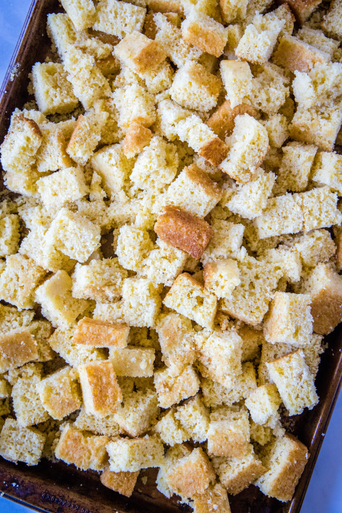 Overhead view of a tray of cornbread chunks