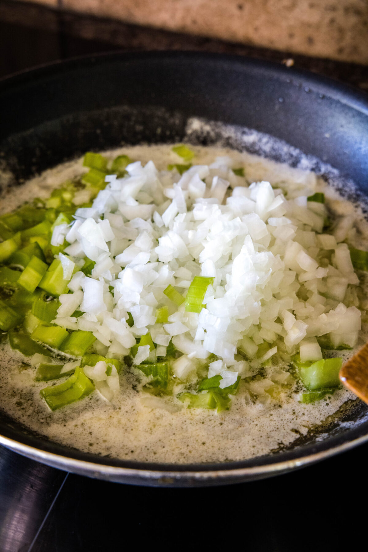 Onions and celery in a skillet with butter
