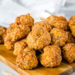 Cheesy Sausage Meatballs - A classic comfort food appetizer that is perfect for your holiday party!  So easy to make, ready in minutes, and they disappear every time. 