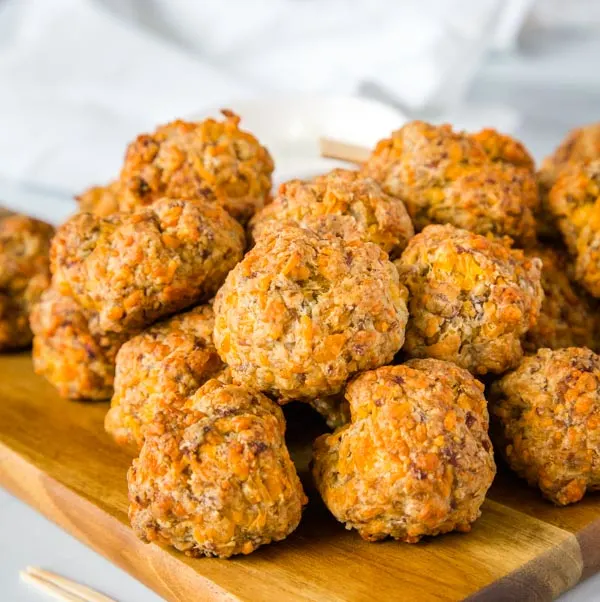 Cheesy Sausage Meatballs - A classic comfort food appetizer that is perfect for your holiday party!  So easy to make, ready in minutes, and they disappear every time. 