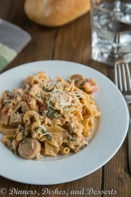 Creamy Sausage Spinach Pasta - a quick and easy meal the whole family will love. Pasta, sausage, and spinach in a creamy tomato sauce.