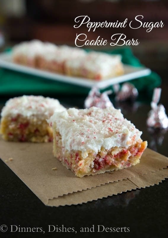 Peppermint Sugar Cookie Bars - Sugar Cookies in the form of a bar. Thick, chewy, and full of peppermint chips. Topped with a butter cream frosting and more peppermint shavings!