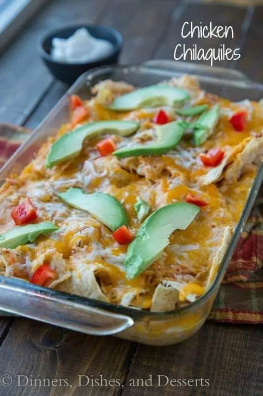 Chicken Chilaquiles -A Mexican casserole with tortilla chips, and chicken baked in a spicy tomato sauce, and topped cheese.