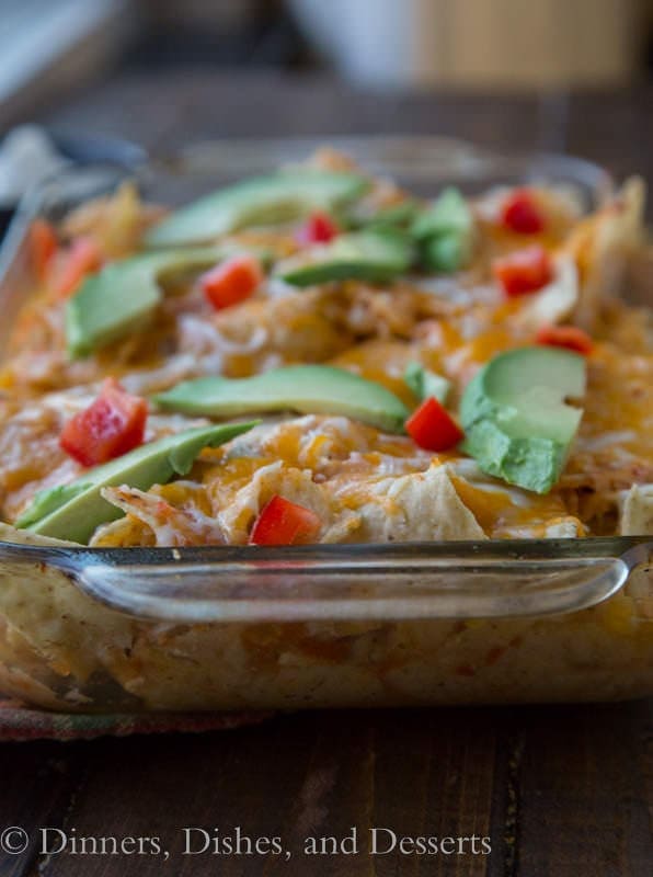 Chicken Chilaquiles -A Mexican casserole with tortilla chips, and chicken baked in a spicy tomato sauce, and topped cheese.