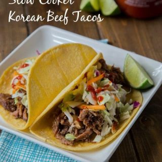 Slow Cooker Korean Beef Tacos - Let your crock pot do the work and get perfectly tender, sweet and spicy beef that is perfect piled on a tortilla topped with a little Korean coleslaw.
