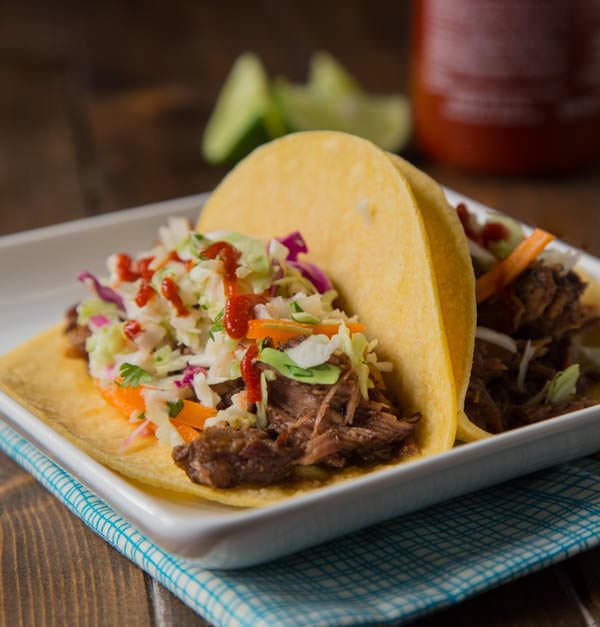 Slow Cooker Korean Beef Tacos - Let your crock pot do the work and get perfectly tender, sweet and spicy beef that is perfect piled on a tortilla topped with a little Korean coleslaw.