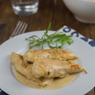 Chicken with Tarragon –Mustard Sauce is a creamy, tangy sauce that comes together in minutes. Turn plain old chicken into something special even on a busy weeknight. My kitchen has kind of turned into a disaster zone lately. It all started when our freezer started leaking water (inside the freezer), and coating the whole thing in ice. To replace it meant having to remodel a portion of our kitchen. The fridge that came with the house was a custom, built-in fridge. FYI – those are extra wide! You can’t just replace them with a normal size fridge, because you end up with a 6 inch gap between the fridge and the cabinet next to it. Not to mention the giant gap above it, because they are also extra tall. So yeah, fun times at my house! Considering the disaster zone that is my kitchen right now, I have to figure out how to cook dinner without an oven and in a small usable space. This chicken with tarragon-mustard sauce is perfect. Everything is made in just one pan, and ready in less than 20 minutes. I used chicken tenders because that is what I had on hand, but cutlets would be done even faster. The tarragon-mustard sauce is creamy and just a little tangy from the mustard. The tarragon gives a hint of licorice flavor, but definitely not over powering. Everyone at my house pretty much licked their plates clean, they loved the sauce so much. You could even serve over egg noodles to soak up all that goodness. I served mine with a giant salad but pan charred asparagus or cheesy garlic pull apart bread would be really good as well. My husband thought the leftovers were great the next day for lunch too. Definitely a great quick and easy weeknight meal that turns ordinary chicken into something special.