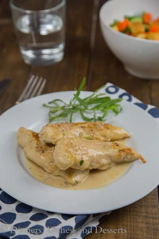 Chicken with Tarragon –Mustard Sauce is a creamy, tangy sauce that comes together in minutes. Turn plain old chicken into something special even on a busy weeknight. My kitchen has kind of turned into a disaster zone lately. It all started when our freezer started leaking water (inside the freezer), and coating the whole thing in ice. To replace it meant having to remodel a portion of our kitchen. The fridge that came with the house was a custom, built-in fridge. FYI – those are extra wide! You can’t just replace them with a normal size fridge, because you end up with a 6 inch gap between the fridge and the cabinet next to it. Not to mention the giant gap above it, because they are also extra tall. So yeah, fun times at my house! Considering the disaster zone that is my kitchen right now, I have to figure out how to cook dinner without an oven and in a small usable space. This chicken with tarragon-mustard sauce is perfect. Everything is made in just one pan, and ready in less than 20 minutes. I used chicken tenders because that is what I had on hand, but cutlets would be done even faster. The tarragon-mustard sauce is creamy and just a little tangy from the mustard. The tarragon gives a hint of licorice flavor, but definitely not over powering. Everyone at my house pretty much licked their plates clean, they loved the sauce so much. You could even serve over egg noodles to soak up all that goodness. I served mine with a giant salad but pan charred asparagus or cheesy garlic pull apart bread would be really good as well. My husband thought the leftovers were great the next day for lunch too. Definitely a great quick and easy weeknight meal that turns ordinary chicken into something special.