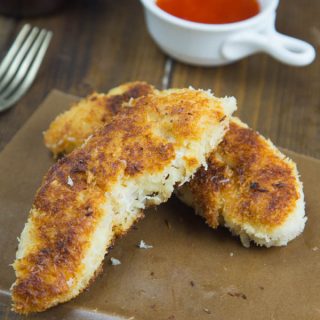 coconut crusted chicken tenders on a board