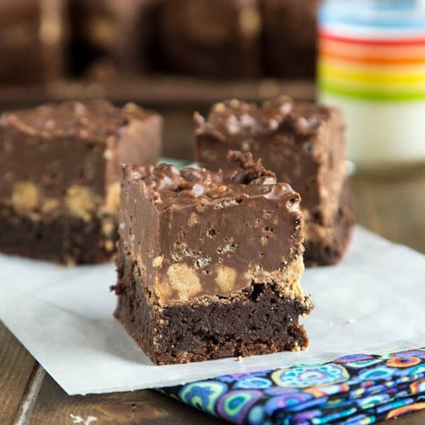 Peanut Butter Crunch Brownies - A fudgy brownie, topped with a layer of peanut butter cups, and then a layer of chocolate/peanut butter crispy fudge. Pure chocolate and peanut butter heaven!