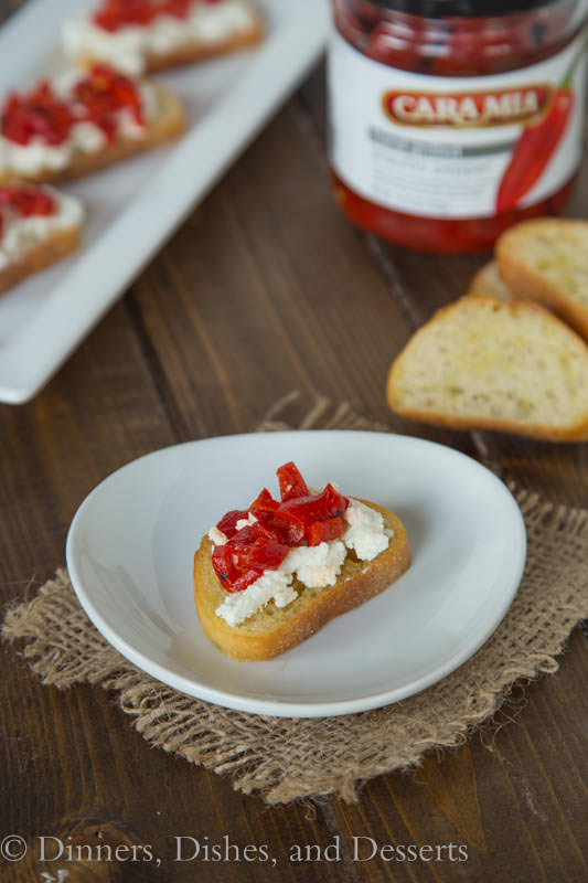 Piquillo Pepper and Goat Cheese Crostini - crispy crostini topped with goat cheese, chopped piquillo peppers and drizzled with balsamic vinegar. The perfect easy appetizer for any get together.