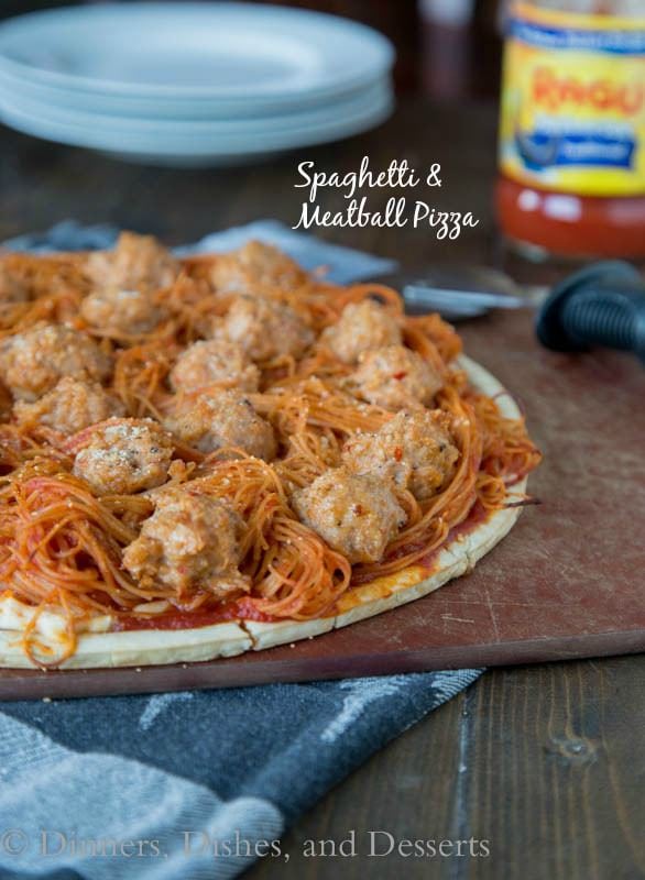 spaghetti and meatball pizza on a board