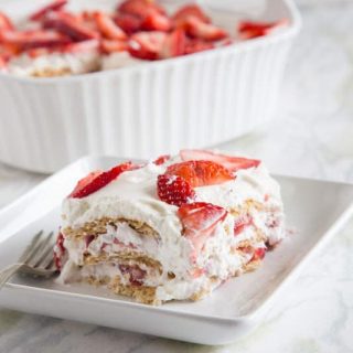 Strawberry Ice Box Cake - no bake cake that is perfect for summer. Layers of fresh whipped cream, strawberries, and graham crackers. It will disappear quickly!