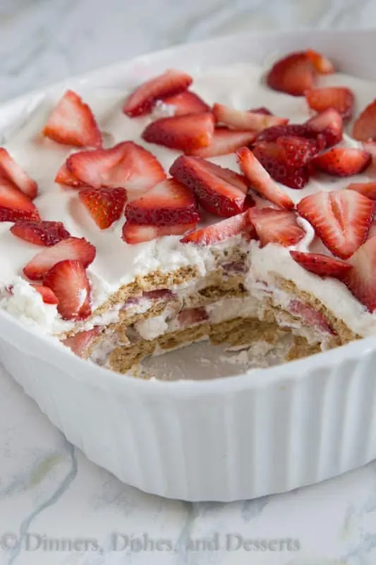 Strawberry Ice Box Cake - no bake cake that is perfect for summer. Layers of fresh whipped cream, strawberries, and graham crackers. It will disappear quickly!