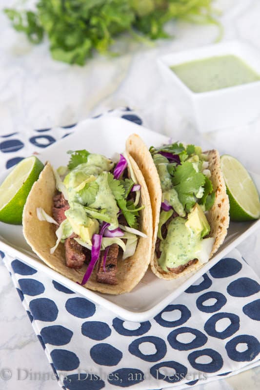 Skirt steak street tacos – tender grilled skirt steak wrapped in a charred corn tortilla and topped with a creamy cilantro lime sauce. Just like Southern California at home in no time!