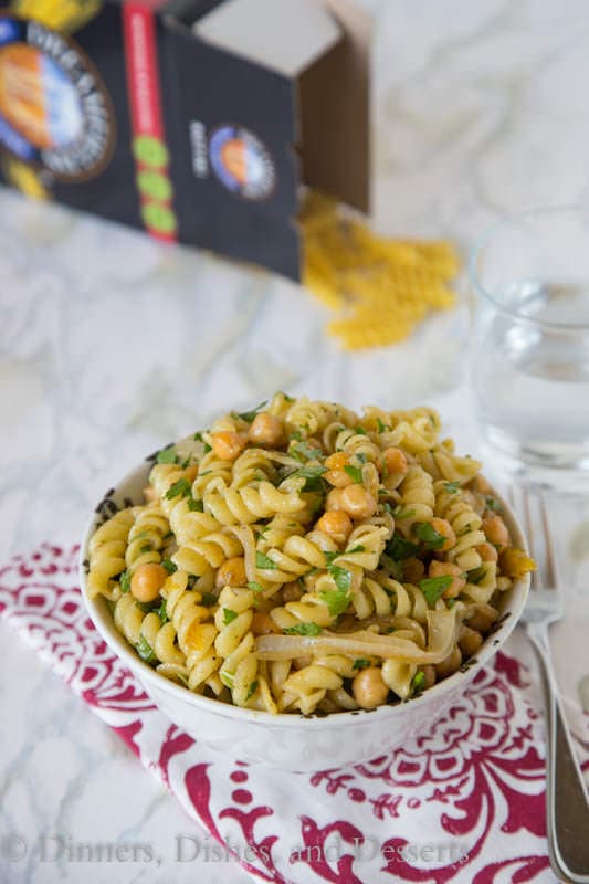 Middle Eastern Pasta Salad - put a spin on your traditional pasta salad with a chutney lime vinaigrette, chickpeas, cumin and sauteed onions. It is great served hot or cold!