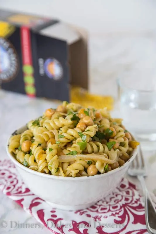 Middle Eastern Pasta Salad - put a spin on your traditional pasta salad with a chutney lime vinaigrette, chickpeas, cumin and sauteed onions. It is great served hot or cold!